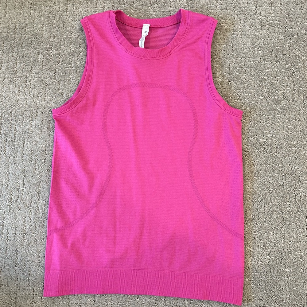 Lululemon swiftly tech muscle tank top in the color sonic pink.